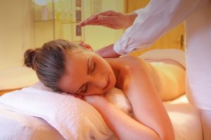 Patient receiving massage therapy in a relaxing environment